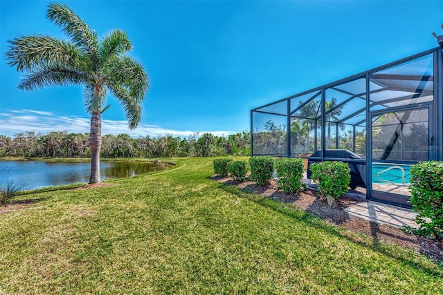 view of yard featuring a lanai and a water view