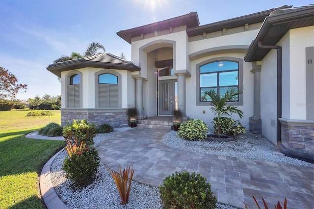 doorway to property featuring a yard