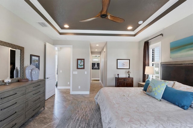 bedroom with ceiling fan, a raised ceiling, and ornamental molding