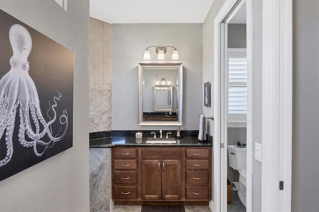 bathroom featuring vanity and toilet