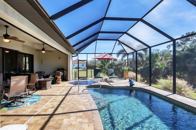 view of pool featuring a patio area, ceiling fan, and glass enclosure