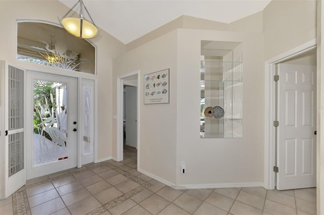 entrance foyer with light tile patterned flooring and french doors