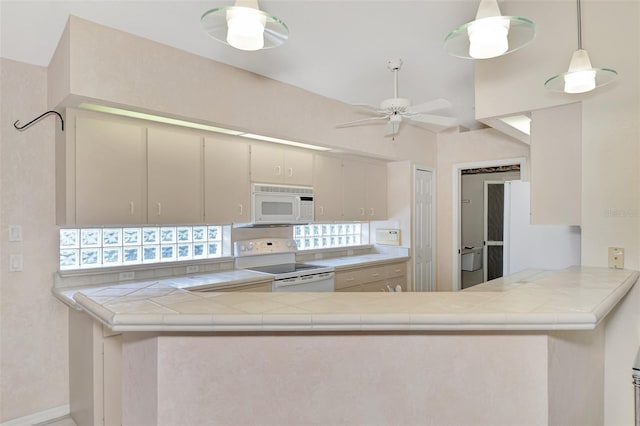 kitchen with kitchen peninsula, white appliances, ceiling fan, decorative light fixtures, and lofted ceiling