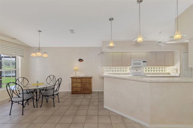 kitchen with pendant lighting, stove, ceiling fan with notable chandelier, vaulted ceiling, and light tile patterned flooring