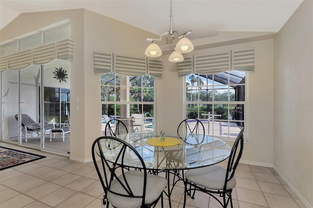 tiled dining room with an inviting chandelier and lofted ceiling