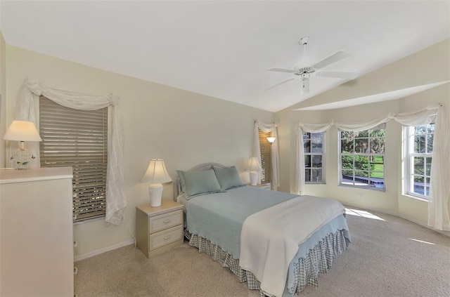 bedroom featuring ceiling fan, lofted ceiling, and light carpet