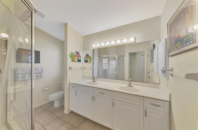 bathroom featuring vanity, tile patterned floors, toilet, a textured ceiling, and an enclosed shower