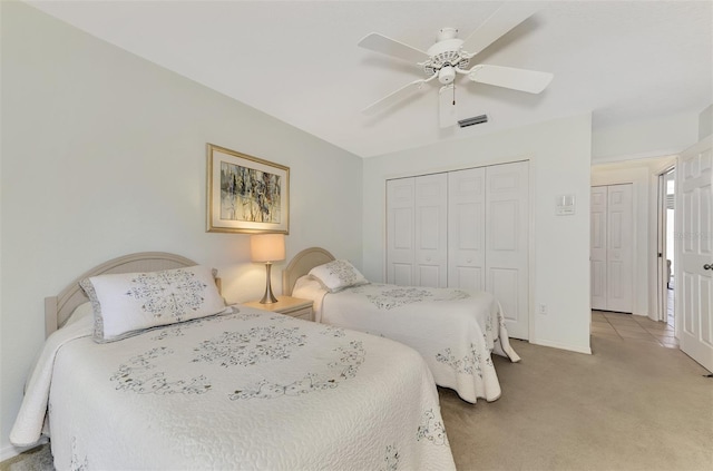 bedroom featuring ceiling fan, a closet, and carpet