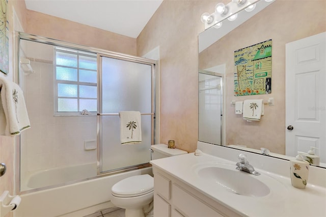 full bathroom featuring tile patterned flooring, vanity, bath / shower combo with glass door, and toilet