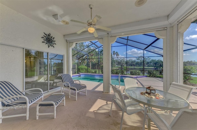 sunroom featuring ceiling fan and a pool