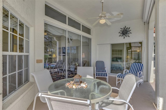 sunroom / solarium featuring ceiling fan