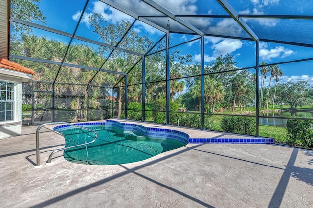 view of pool featuring glass enclosure, a patio area, and a water view