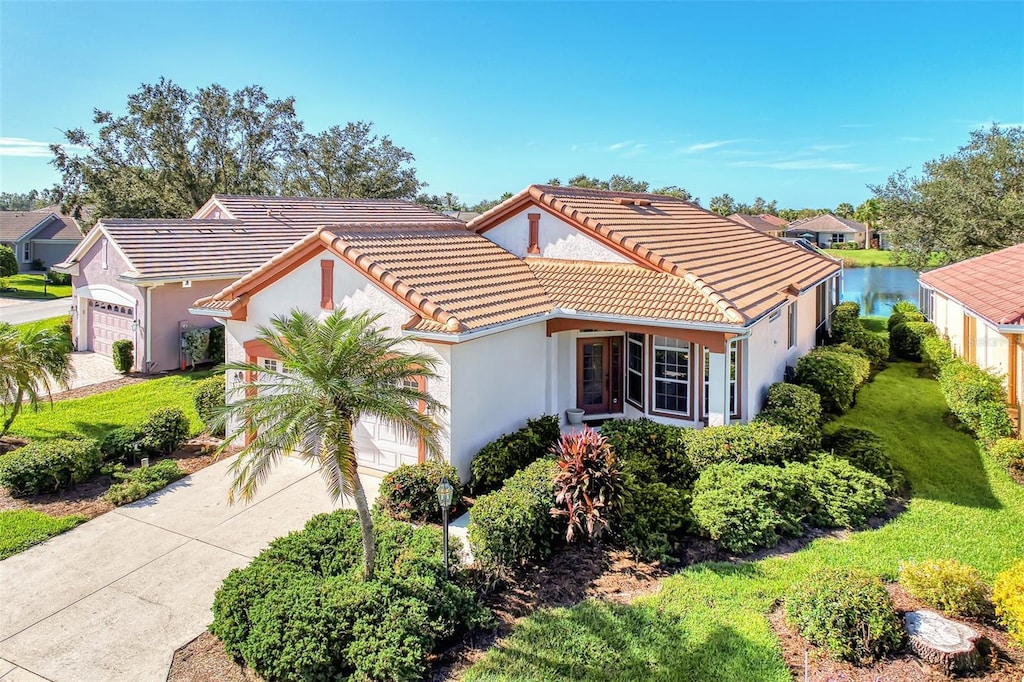 3238 Osprey Ln, Port Charlotte, FL 33953 - mediterranean / spanish-style home featuring a garage and a water view