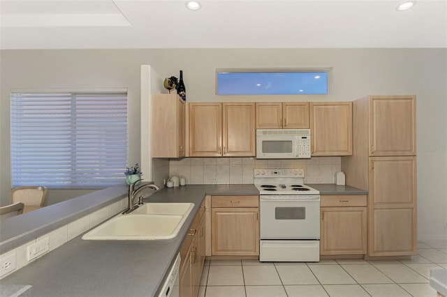 kitchen with decorative backsplash, sink, white appliances, light brown cabinets, and light tile patterned floors