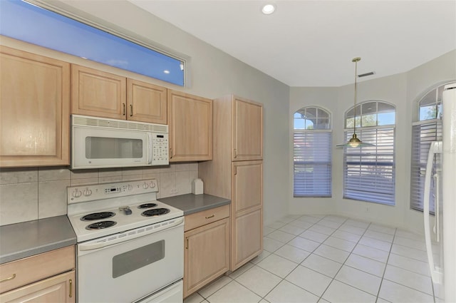 kitchen featuring decorative light fixtures, light brown cabinetry, tasteful backsplash, and white appliances