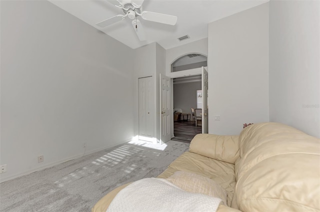 carpeted living room with ceiling fan