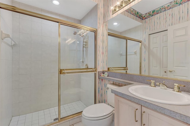 bathroom with toilet, walk in shower, and vanity