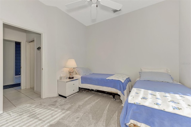 bedroom with ceiling fan, light tile patterned floors, and lofted ceiling