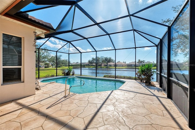 view of pool featuring glass enclosure, a water view, and a patio