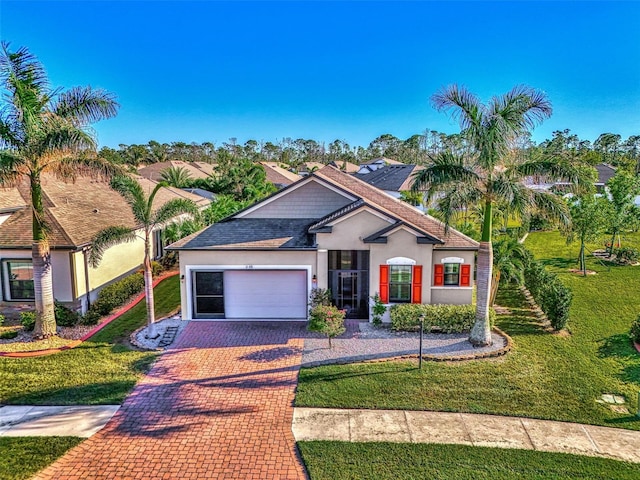 view of front of property featuring a front yard and a garage