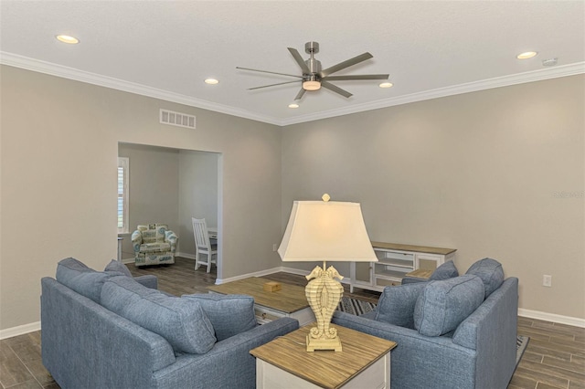 living room featuring dark hardwood / wood-style flooring, ceiling fan, and crown molding