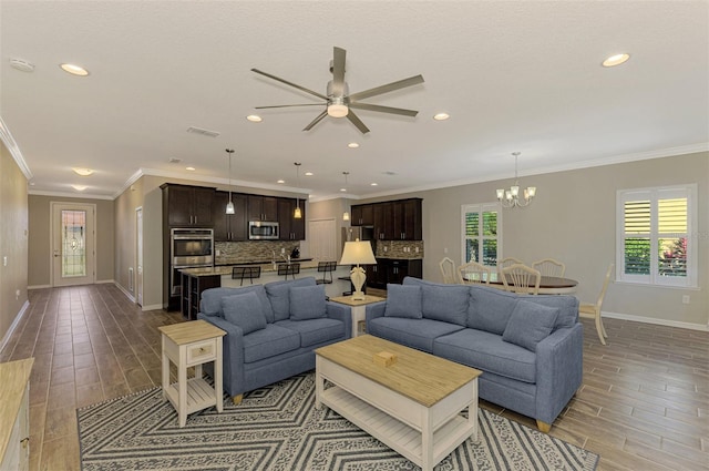 2148 La Palma Ave, Port Charlotte, FL 33953 - living area with wood finish floors, ceiling fan, ornamental molding, a chandelier, and recessed lighting