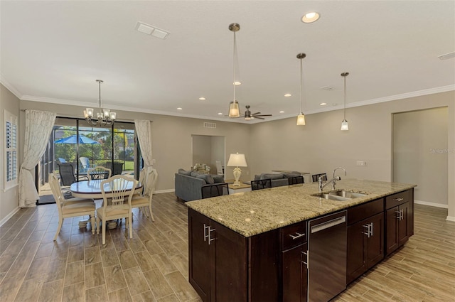 kitchen featuring light stone countertops, ceiling fan with notable chandelier, sink, a center island with sink, and dishwasher