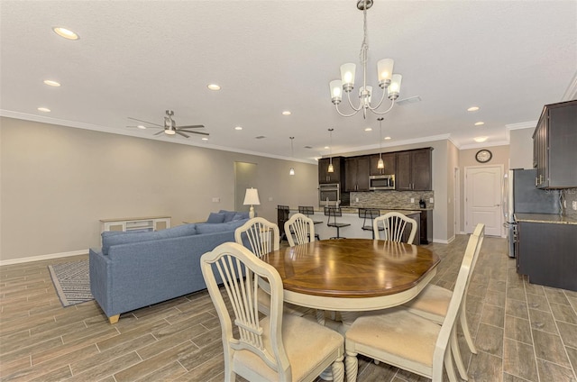 dining area featuring light hardwood / wood-style floors, ceiling fan with notable chandelier, and ornamental molding