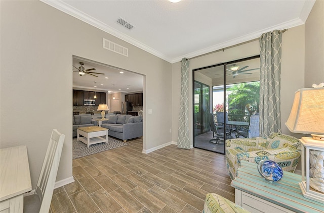 living room with wood-type flooring and ornamental molding