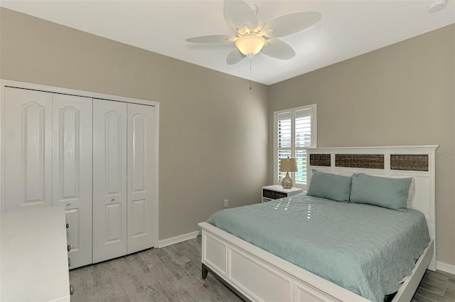 bedroom with a closet, ceiling fan, and hardwood / wood-style floors