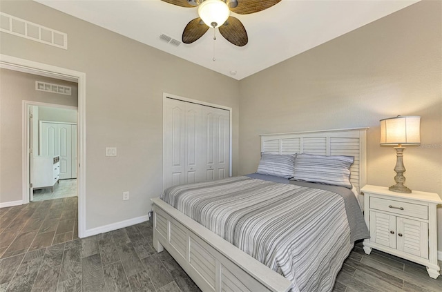 bedroom featuring dark hardwood / wood-style flooring, ceiling fan, a closet, and lofted ceiling