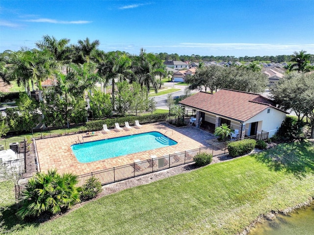 view of swimming pool with a lawn and a patio