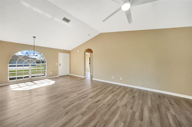 unfurnished living room with lofted ceiling, ceiling fan, and light wood-type flooring