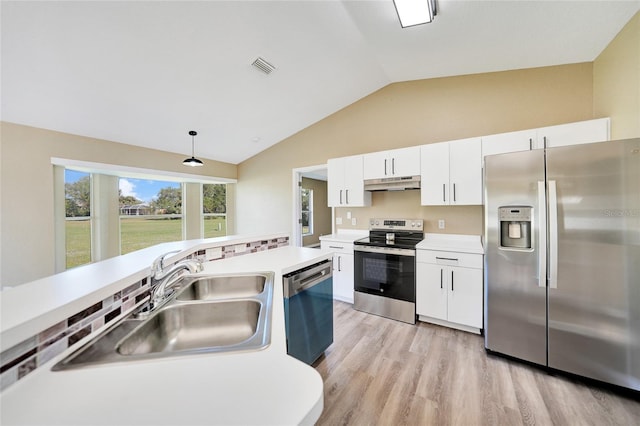 kitchen featuring appliances with stainless steel finishes, light wood-type flooring, pendant lighting, white cabinetry, and lofted ceiling