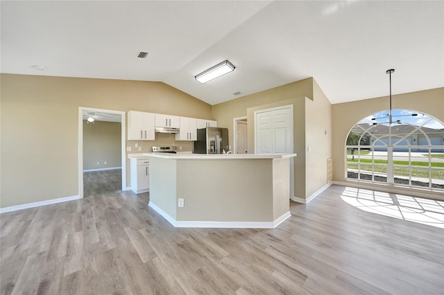 kitchen with white cabinets, stainless steel appliances, hanging light fixtures, and light hardwood / wood-style flooring