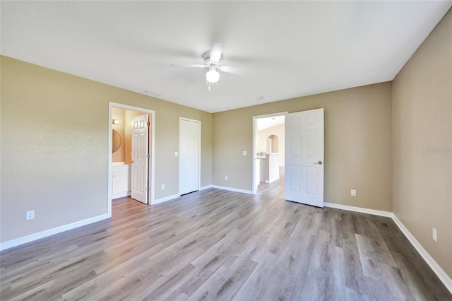 spare room featuring ceiling fan and light hardwood / wood-style flooring