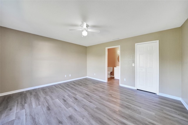 unfurnished room featuring light wood-type flooring and ceiling fan