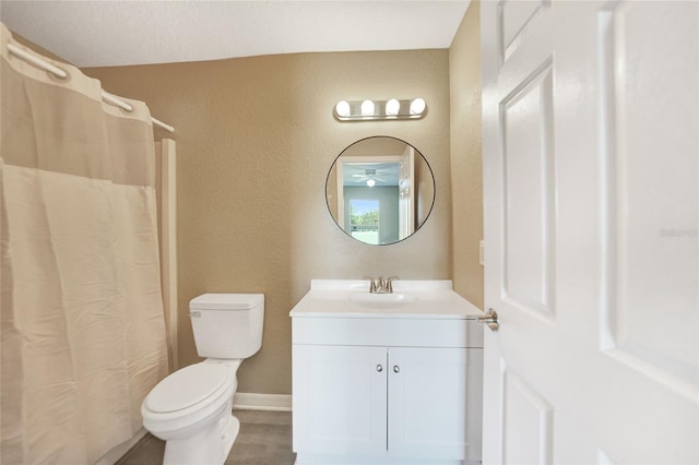 bathroom featuring vanity, curtained shower, toilet, and a textured ceiling