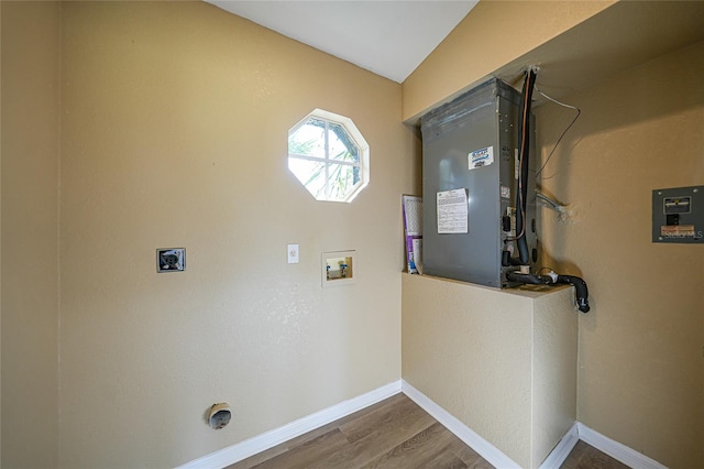 laundry room featuring electric dryer hookup, hookup for a washing machine, and wood-type flooring