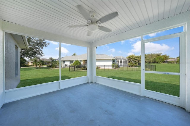 unfurnished sunroom featuring ceiling fan