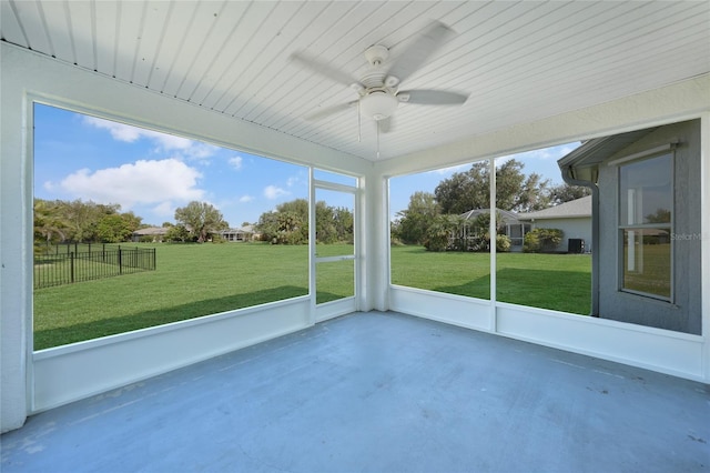 unfurnished sunroom featuring ceiling fan