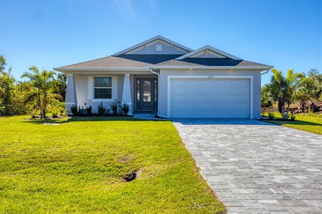 view of front facade with a garage and a front lawn