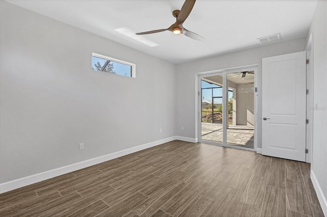 empty room with dark hardwood / wood-style floors and ceiling fan