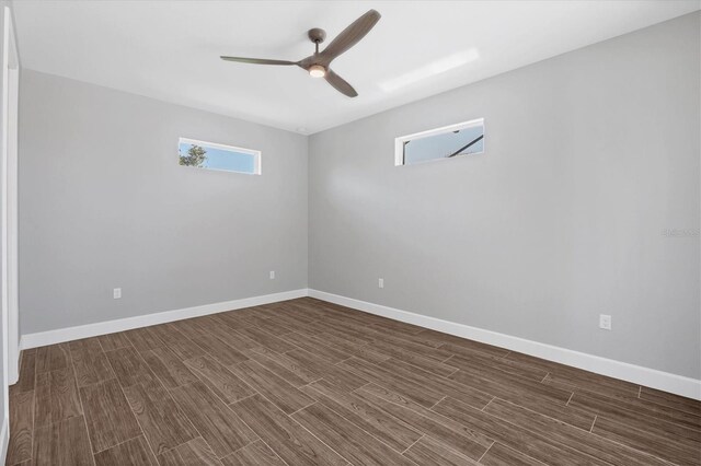 spare room featuring dark hardwood / wood-style flooring and ceiling fan