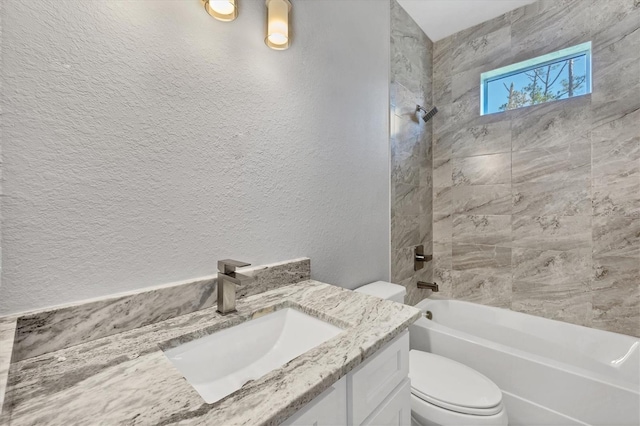 full bathroom with vanity, toilet, and tiled shower / bath