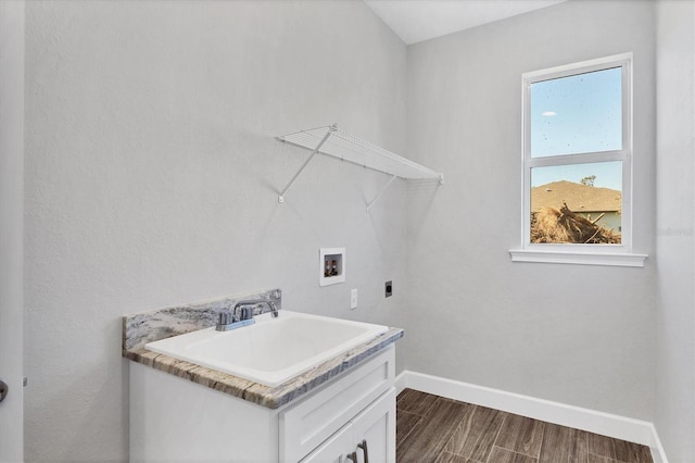 laundry room with cabinets, sink, washer hookup, hardwood / wood-style flooring, and hookup for an electric dryer