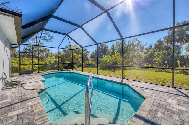 view of swimming pool with glass enclosure and a patio area