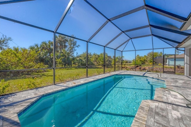 view of swimming pool with glass enclosure and a patio