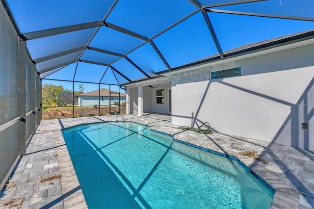 view of pool featuring a lanai, ceiling fan, and a patio