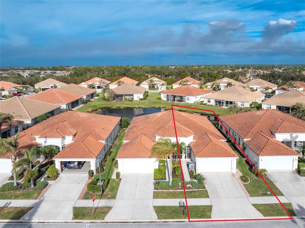 birds eye view of property with a water view